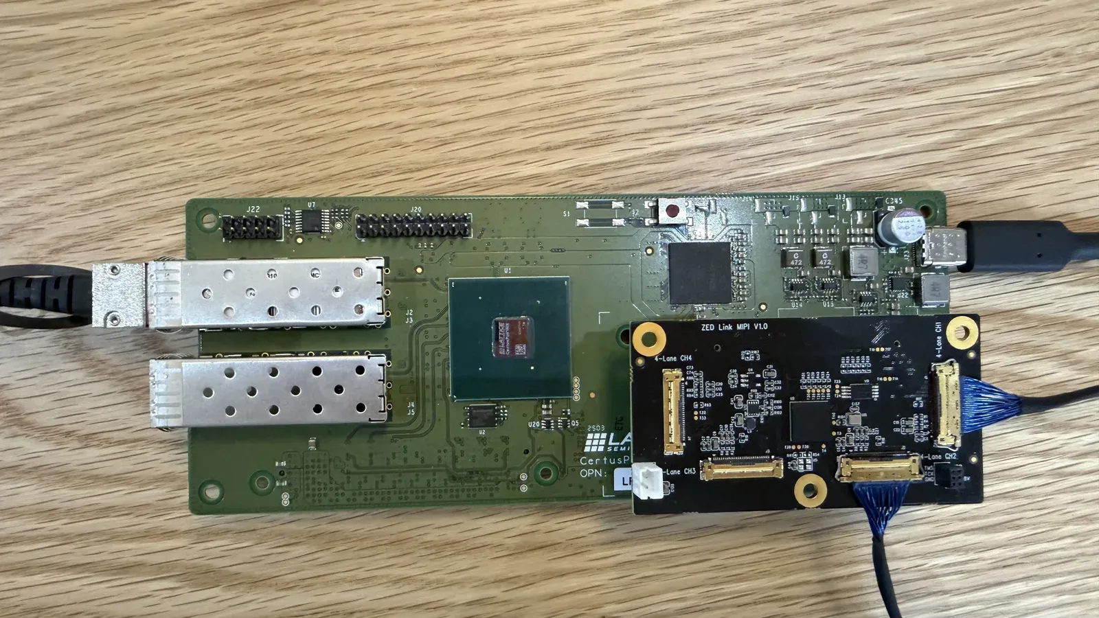 Holoscan Sensor Bridge cabled, with the SFP+ leg in the top cage and the USB-C power cable