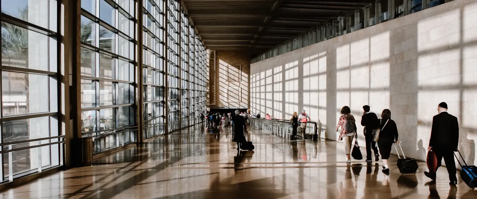 Travelers walking through a station hall