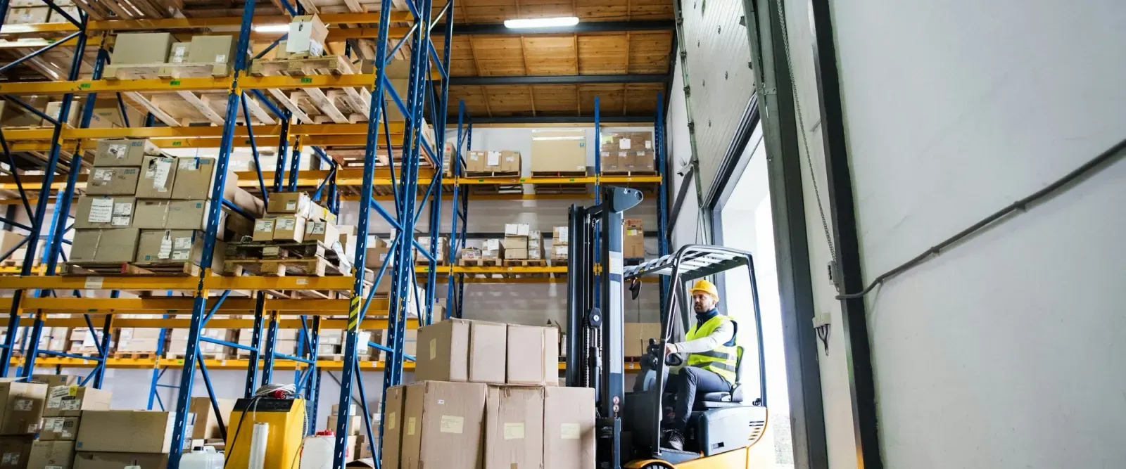 Forklift carrying a pallet in a warehouse
